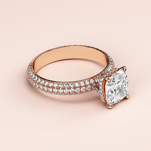 Elegant 14K or 18K rose gold engagement ring with a cushion-cut diamond and sparklingPave band accents.