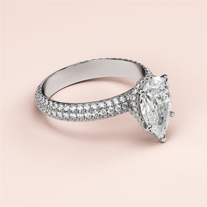 Luxury pear-shaped diamond engagement ring with hidden halo accents, available in 14K or 18K gold and platinum.
