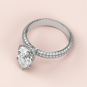 Elegant pear-shaped diamond engagement ring withPave band in 14K gold, featuring hidden halo accents and brilliant-cut diamonds.