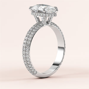 Close-up of a stunning 14K white gold engagement ring featuring a pear-shaped diamond with hidden halo accents and sparkling 3D pave.