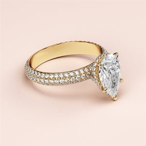 Elegant pear-shaped diamond ring in 14K or 18K gold with hidden halo accents and intricate pave band design.