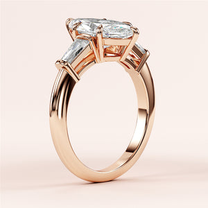 Elegant 14K or 18K rose gold marquise-cut engagement ring with tapered baguette side stones. Perfect for timeless love.