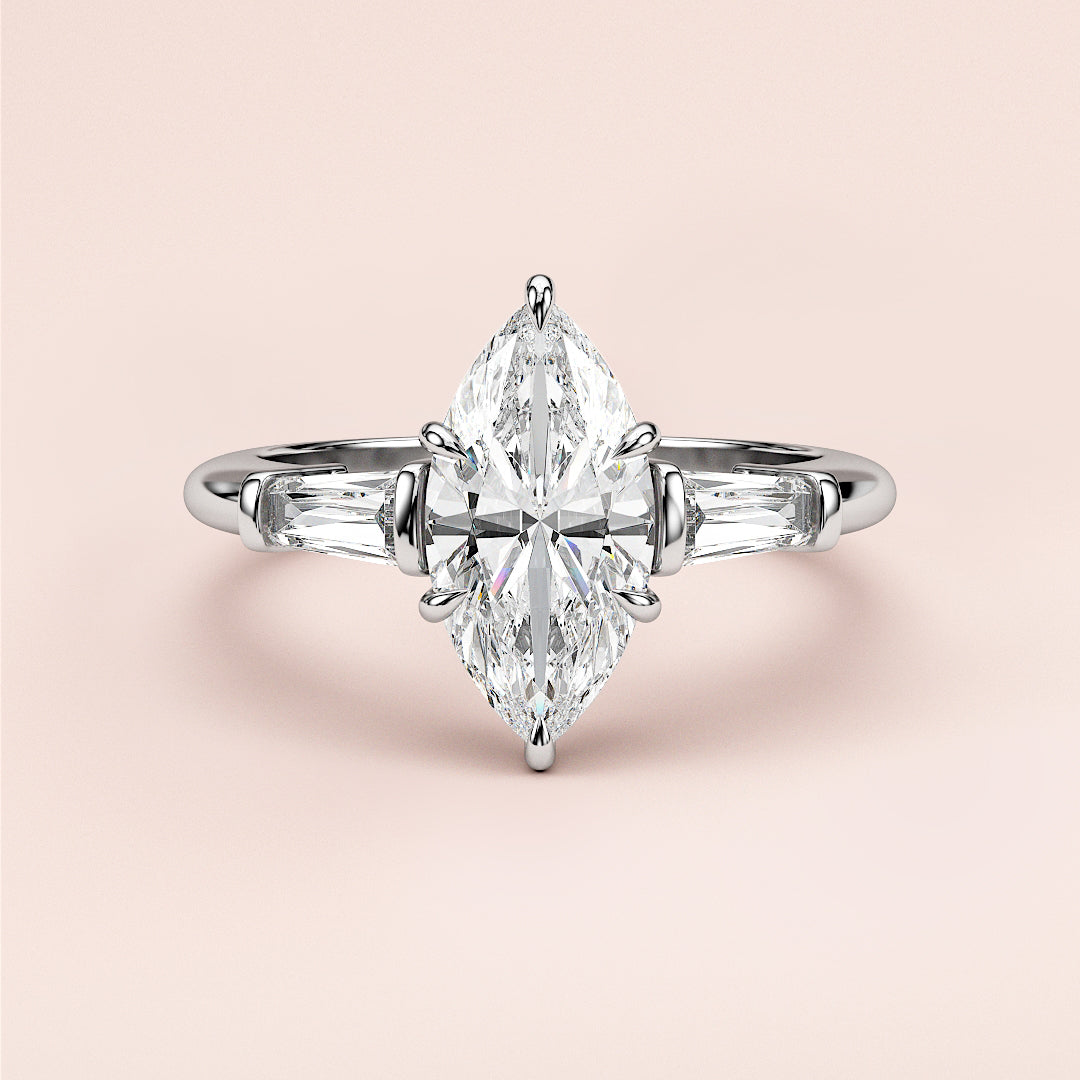 Elegant 14K or 18K white gold engagement ring with marquise-cut diamond centerpiece and tapered baguette accents.