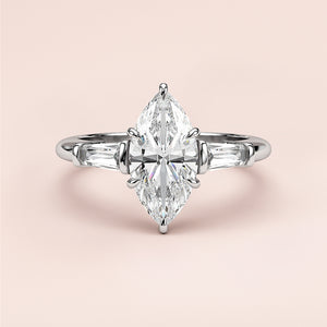 Elegant 14K or 18K white gold engagement ring with marquise-cut diamond centerpiece and tapered baguette accents.