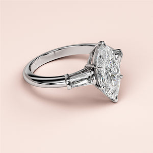 Luxurious 14K/18K white gold engagement ring with marquise-cut diamond and tapered baguette side stones.
