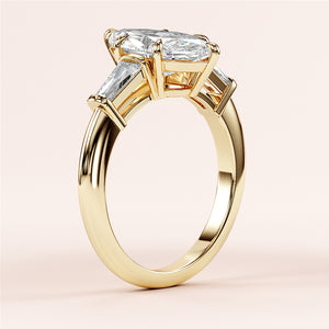Elegant 14K yellow gold engagement ring with marquise-cut diamond and tapered baguette accents, showcasing exquisite craftsmanship.