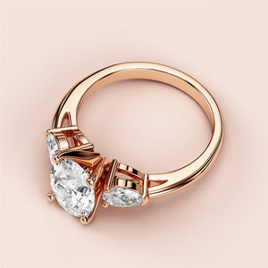 Three-stone engagement ring with oval cut diamonds in rose gold, available in 14K, 18K, or platinum.