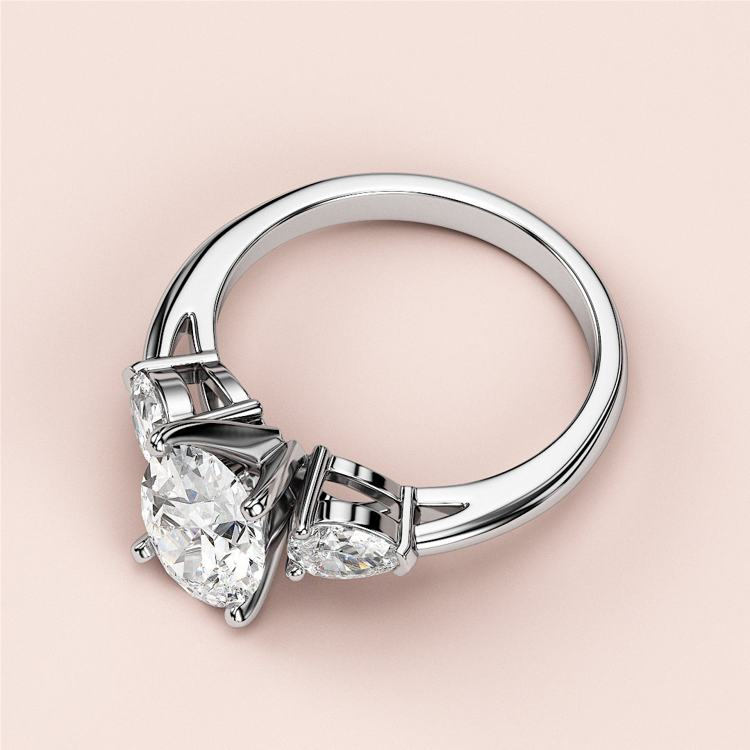 Elegant 14K and 18K white gold engagement ring featuring brilliant round-cut center diamond and marquise side diamonds.