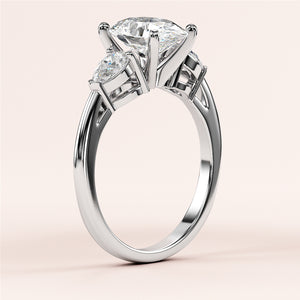 Three-stone pear-shaped diamond engagement ring in 14K gold, featuring a stunning central diamond and two flanking stones.