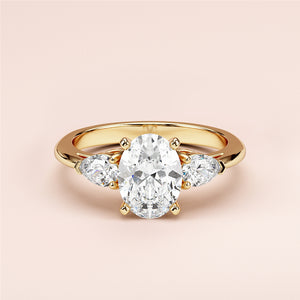 Elegant oval-shaped diamond engagement ring with two pear-shaped side stones, available in 14K or 18K gold or platinum.