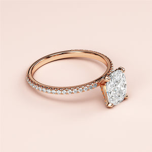 Rose gold engagement ring with a large oval diamond, featuring small round diamonds, available in 14K, 18K, or platinum.