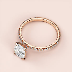 Elegant rose gold engagement ring with oval solitaire and accent diamonds, available in 14K, 18K, or platinum.