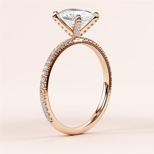 Close-up of an elegant rose gold engagement ring with a marquise diamond andPave band, available in 14K, 18K, or platinum.