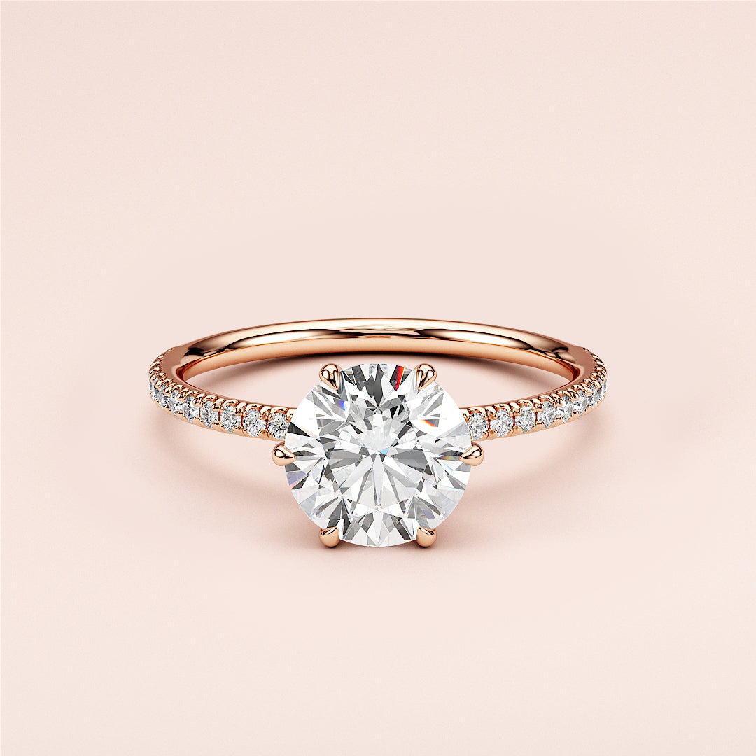 Elegant round-cut diamond engagement ring withPave band in 14K or 18K rose gold, perfect for timeless romance.