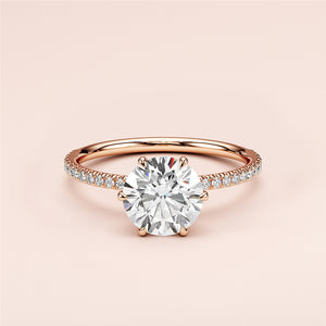 Elegant round-cut diamond engagement ring withPave band in 14K or 18K rose gold, perfect for timeless romance.