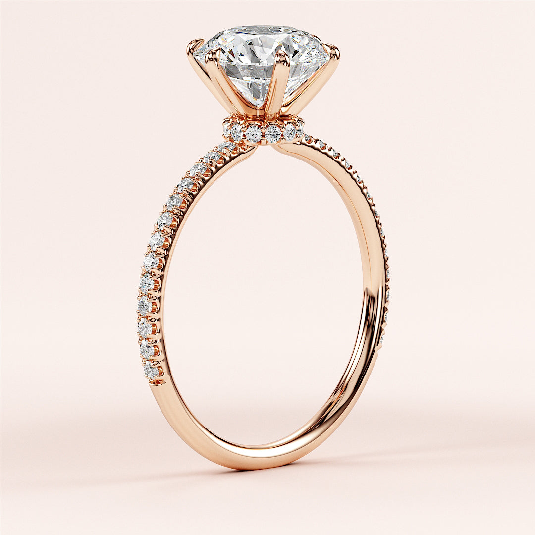 Elegant 14K rose gold engagement ring with round brilliant-cut diamond center andPave accents, showcasing timeless craftsmanship.