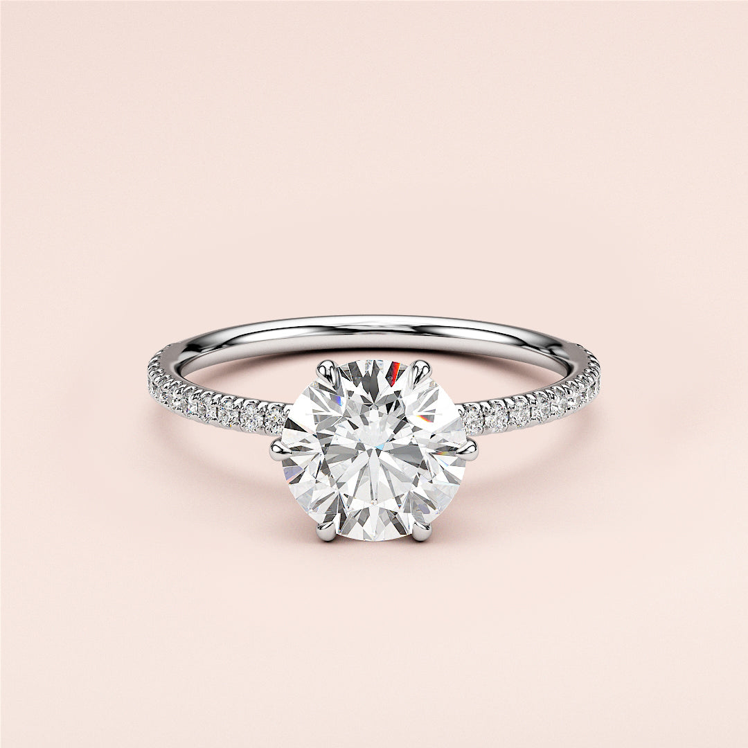 Elegant 14K/18K white gold engagement ring with round brilliant-cut diamond andPave band, not worn on model.