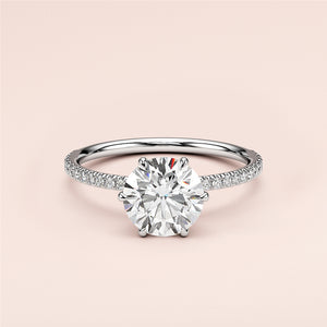 Elegant 14K/18K white gold engagement ring with round brilliant-cut diamond andPave band, not worn on model.