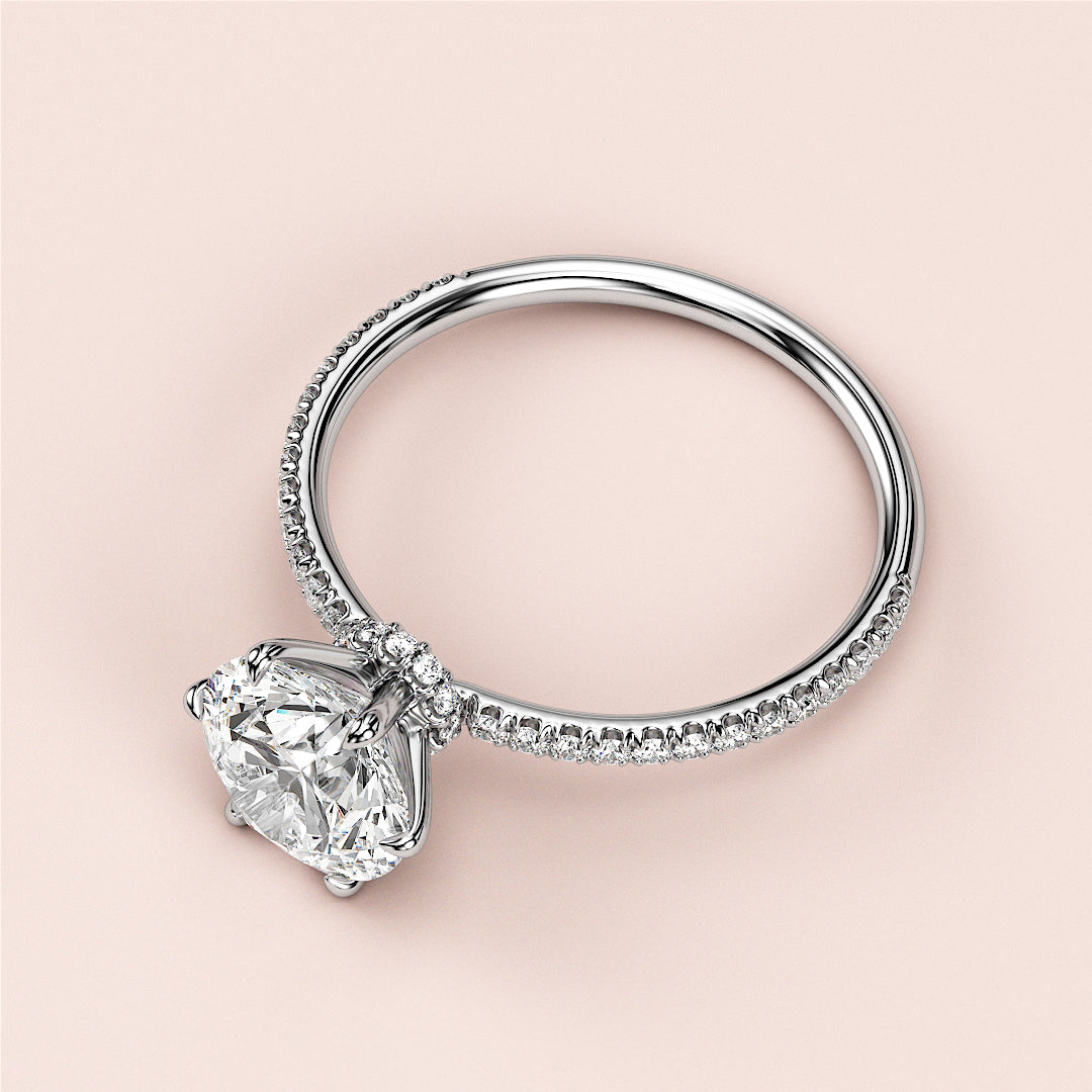 Elegant 14K or 18K white gold engagement ring with cushion-cut diamond and delicatePave band, perfect for any romantic occasion.