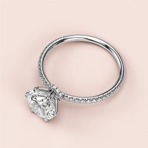 Elegant 14K or 18K white gold engagement ring with cushion-cut diamond and delicatePave band, perfect for any romantic occasion.