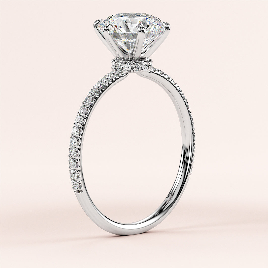 Close-up of a stunning 14K and 18K white gold engagement ring with a round-cut diamond and pave band. Elegant and timeless.