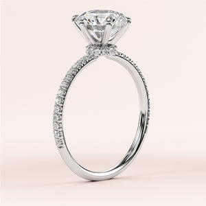 Close-up of a stunning 14K and 18K white gold engagement ring with a round-cut diamond and pave band. Elegant and timeless.