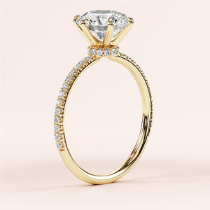 Close-up of a stunning 14K and 18K yellow gold diamond engagement ring with a round halo, prong setting, and pave band.