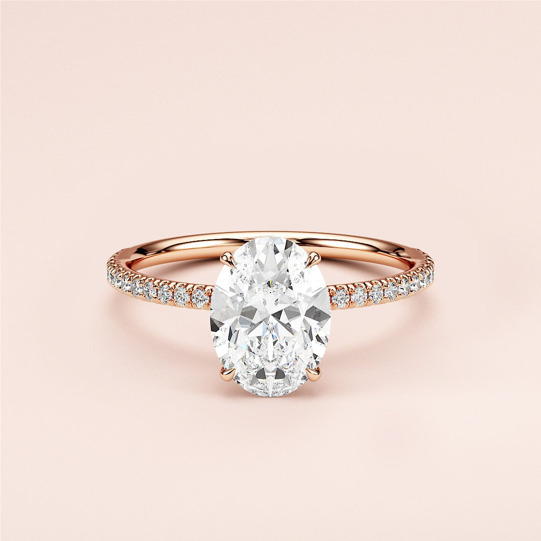 Elegant oval diamond engagement ring in rose gold, featuring aPave band and stunning diamond centerpiece, available in 14K/18K.