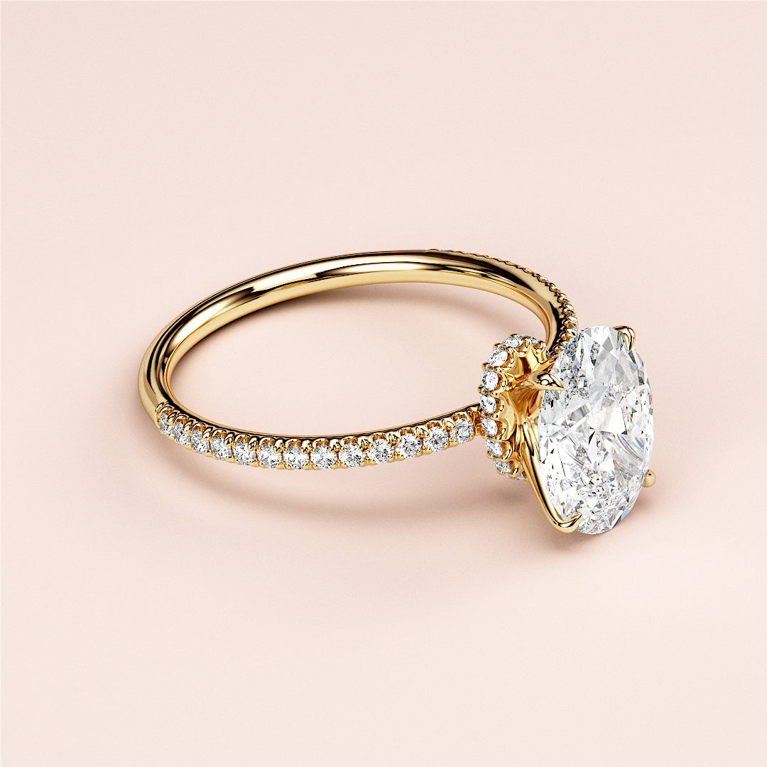 Elegant 14K yellow gold oval solitaire halo engagement ring with pave band, showcasing brilliance and sophistication.