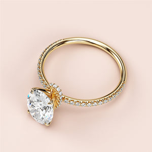Luxurious 14K yellow gold engagement ring with pear-shaped diamond halo and encrusted band, not worn on a model.