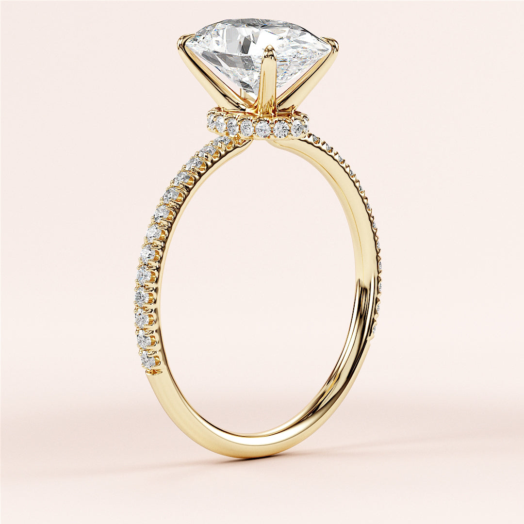 Elegant marquise-cut diamond engagement ring in 14K or 18K gold, featuring a delicate pave setting and sparkling diamond band.