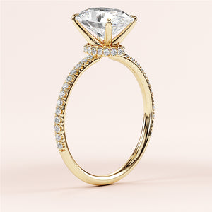 Elegant marquise-cut diamond engagement ring in 14K or 18K gold, featuring a delicate pave setting and sparkling diamond band.