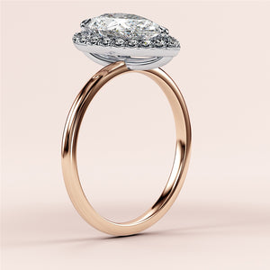 Elegant emerald-cut diamond engagement ring in 14K rose gold, worn on model, featuring a stunning pave band for a timeless look.