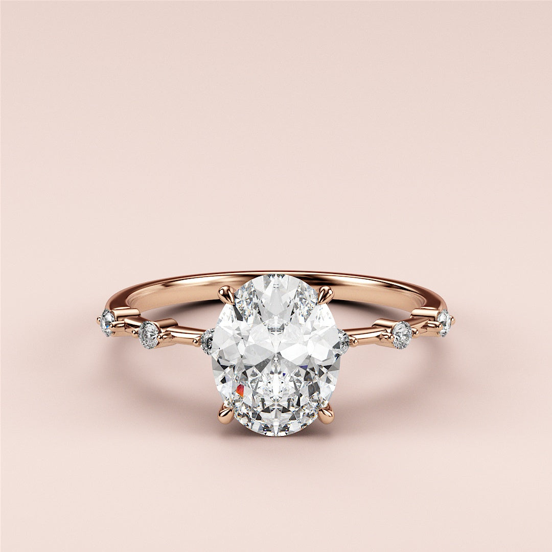 Elegant 14K rose gold engagement ring with an oval diamond centerpiece and shimmering round diamonds along the band.|







#14KRecycledRoseGold
#18KRecycledRoseGold


