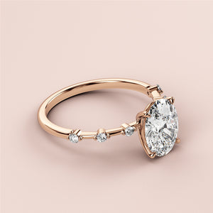 Elegant 14K rose gold engagement ring with oval diamond centerpiece and round diamonds on the band, perfect for proposals.