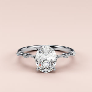 Elegant 14K white gold engagement ring with a dazzling oval diamond center and side diamonds accenting the band.