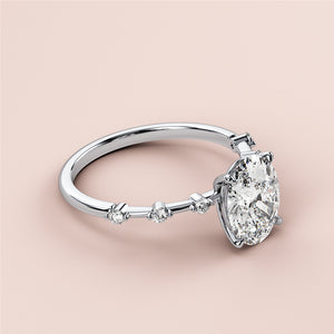 Elegant 14K/18K/Platinum engagement ring featuring an oval diamond center stone with round diamond accents, soft background.
