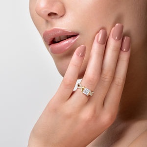 Close-up view of a woman's hand with a Myla princess twisted band pave ring in 14K, 18K gold, or platinum, radiating elegance.