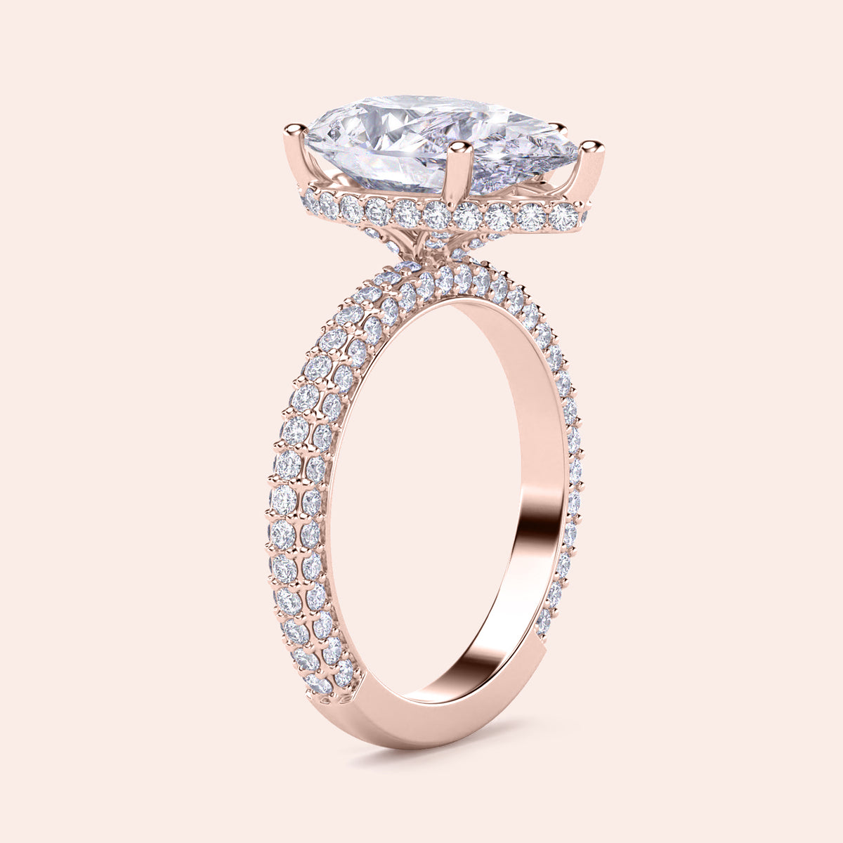"Rose gold engagement ring with pear-shaped diamond, hidden halo, andPave accents, available in 14K or 18K options."