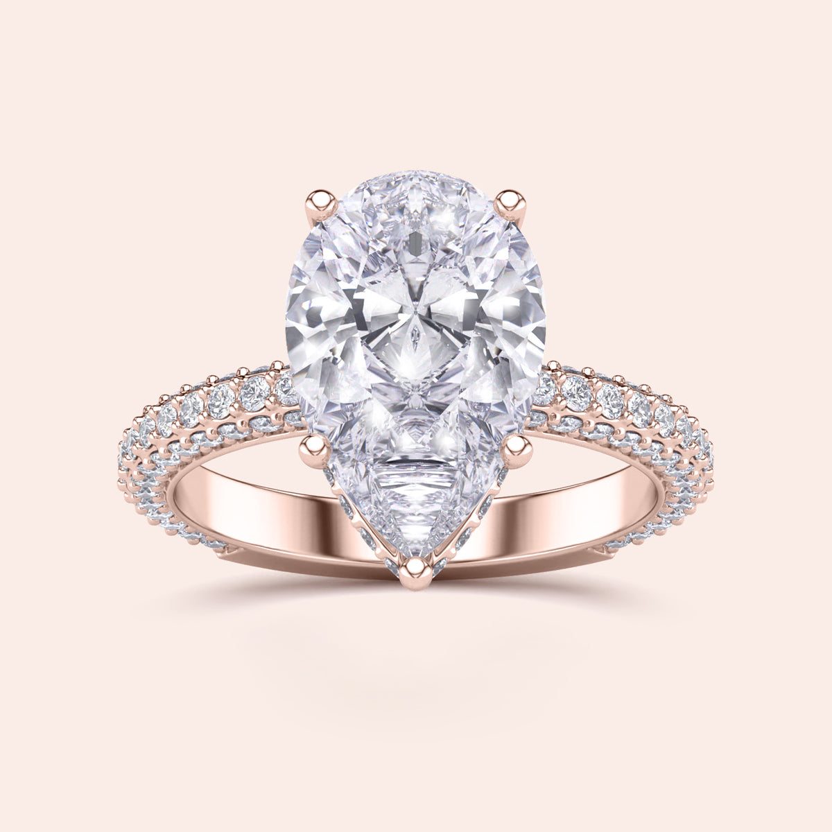 Elegant 14K/18K rose gold pear-shaped diamond engagement ring with hidden halo and prong accents, not worn on model.