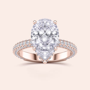 Elegant 14K/18K rose gold pear-shaped diamond engagement ring with hidden halo and prong accents, not worn on model.