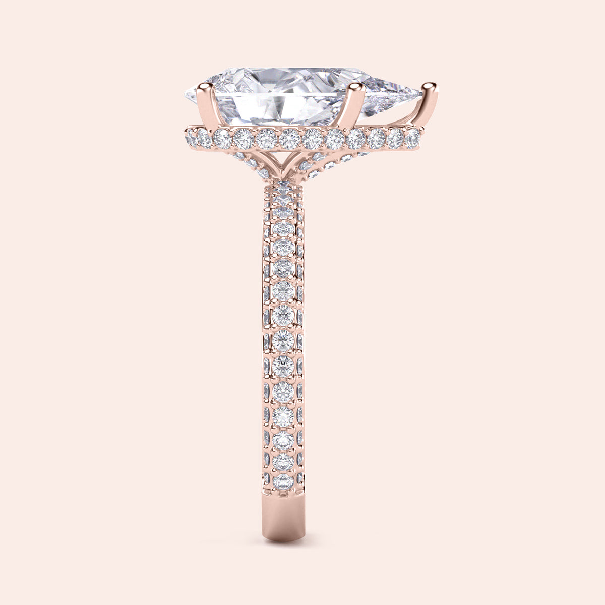 Elegant rose gold engagement ring featuring a pear shape diamond, hidden halo accents, and pave-set diamonds for added brilliance.