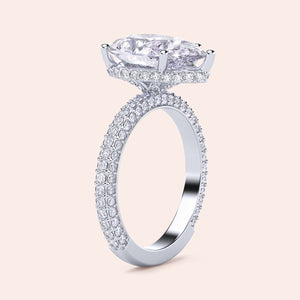 Elegant 14K or 18K white gold engagement ring featuring a pear diamond and halo accents, embellished with pave-set diamonds.