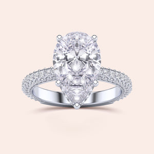 Elegant 14K/18K white gold engagement ring featuring a pear-shaped diamond with a hidden halo and pave accents.
