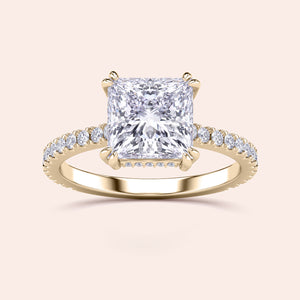 Luxury engagement ring featuring a radiant cut diamond in a 14K or 18K gold band with hidden halo and pave accents.