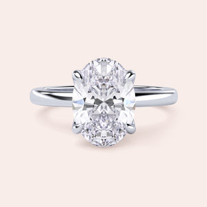 Elegant oval-shaped diamond engagement ring in 14K or 18K gold or platinum, featuring a classic solitaire setting.