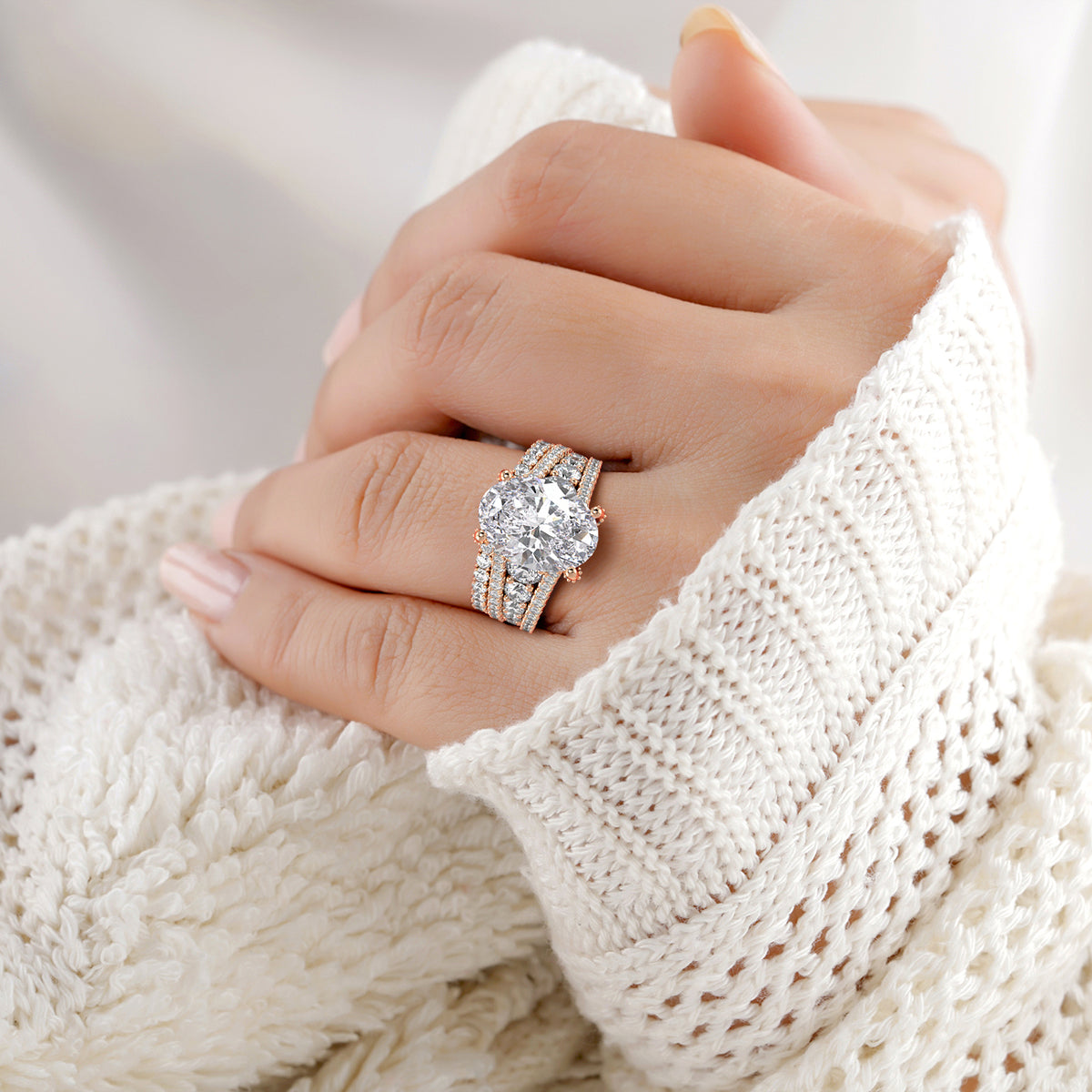 Elegant 14K rose gold diamond engagement ring with oval-cut center stone, worn on a model for a stylish display.