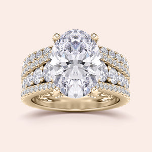 Luxury engagement ring in 14K or 18K gold featuring an oval-cut diamond withPave accents and a three-row band design.