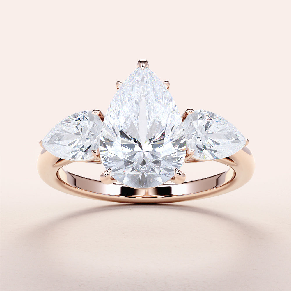 "Elegant 14K/18K gold or platinum pear-shaped diamond engagement ring with side stones, perfect for romantic proposals."
