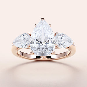 "Elegant 14K/18K gold or platinum pear-shaped diamond engagement ring with side stones, perfect for romantic proposals."